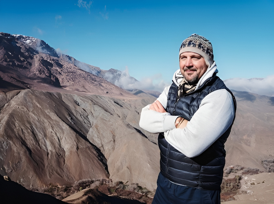 Matthew Patti travelling beside some mountain ranges