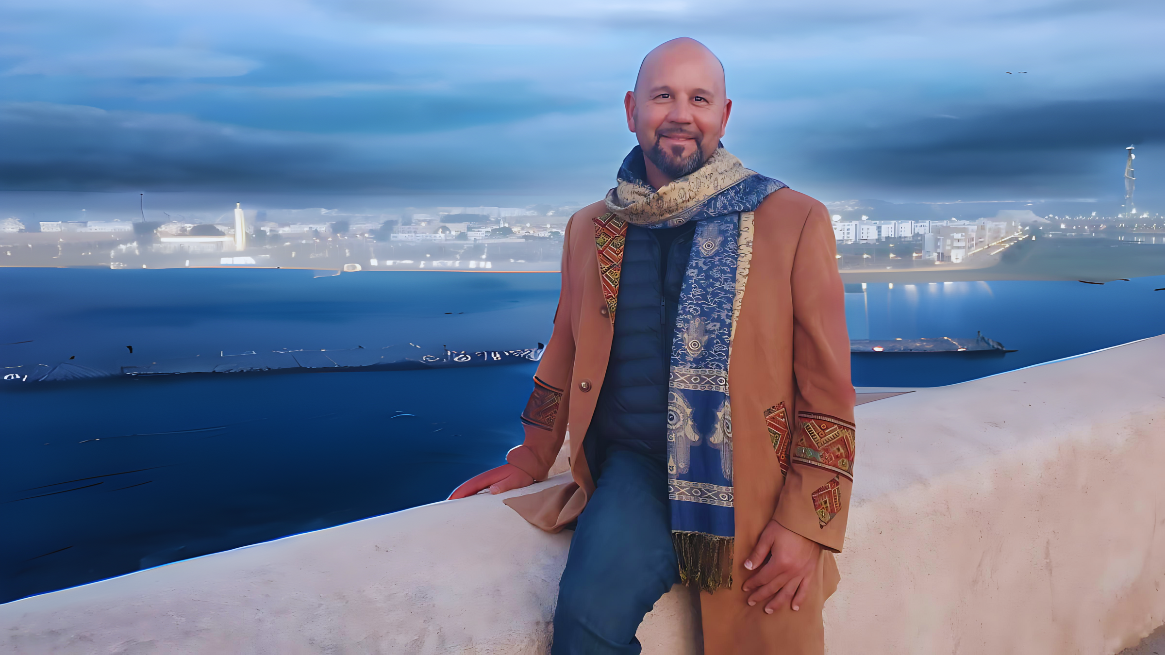 Matthew Patti in a coat and scarf a spiritual business coach